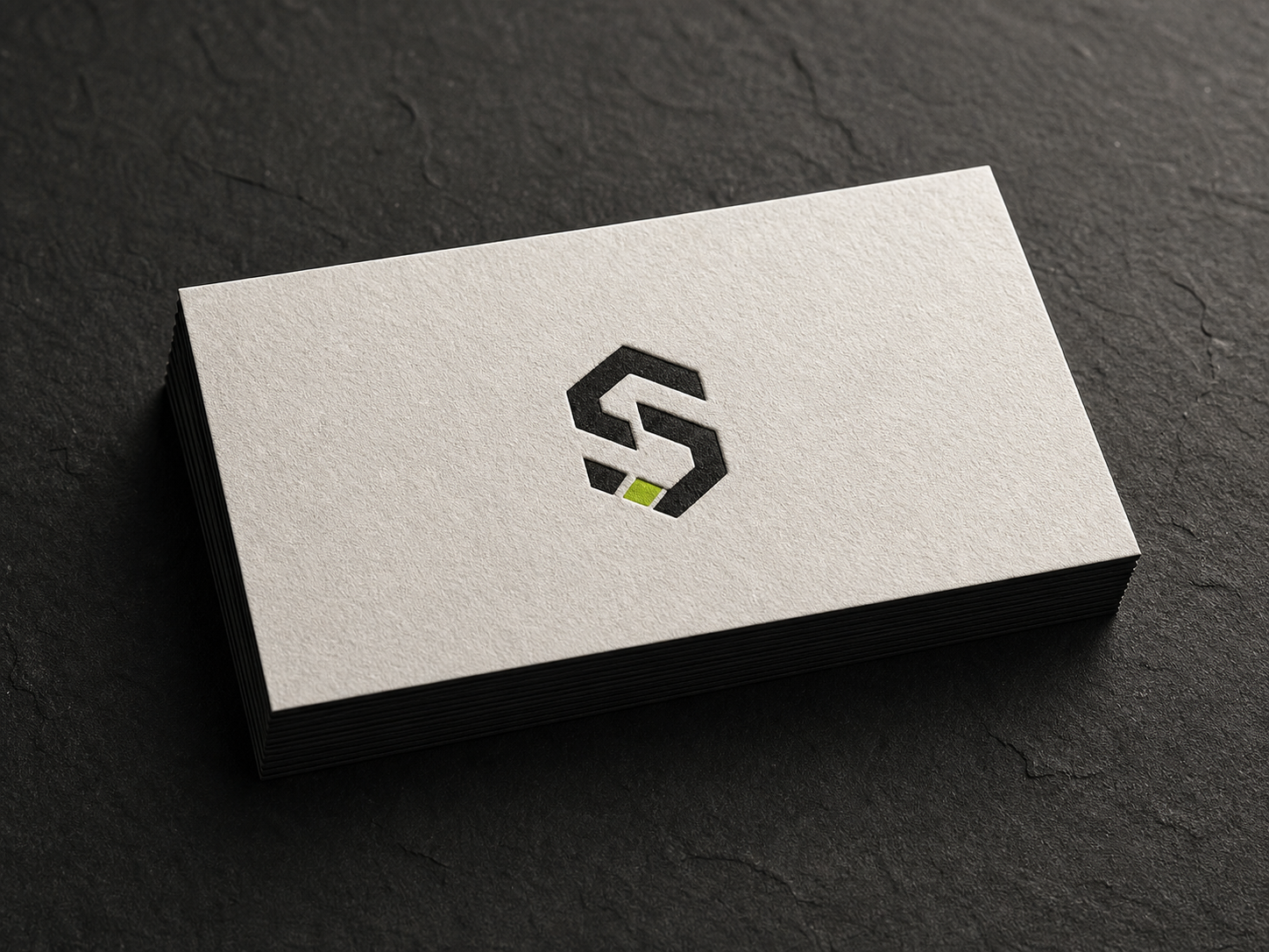 Embossed studio monogram on a stack of premium business cards