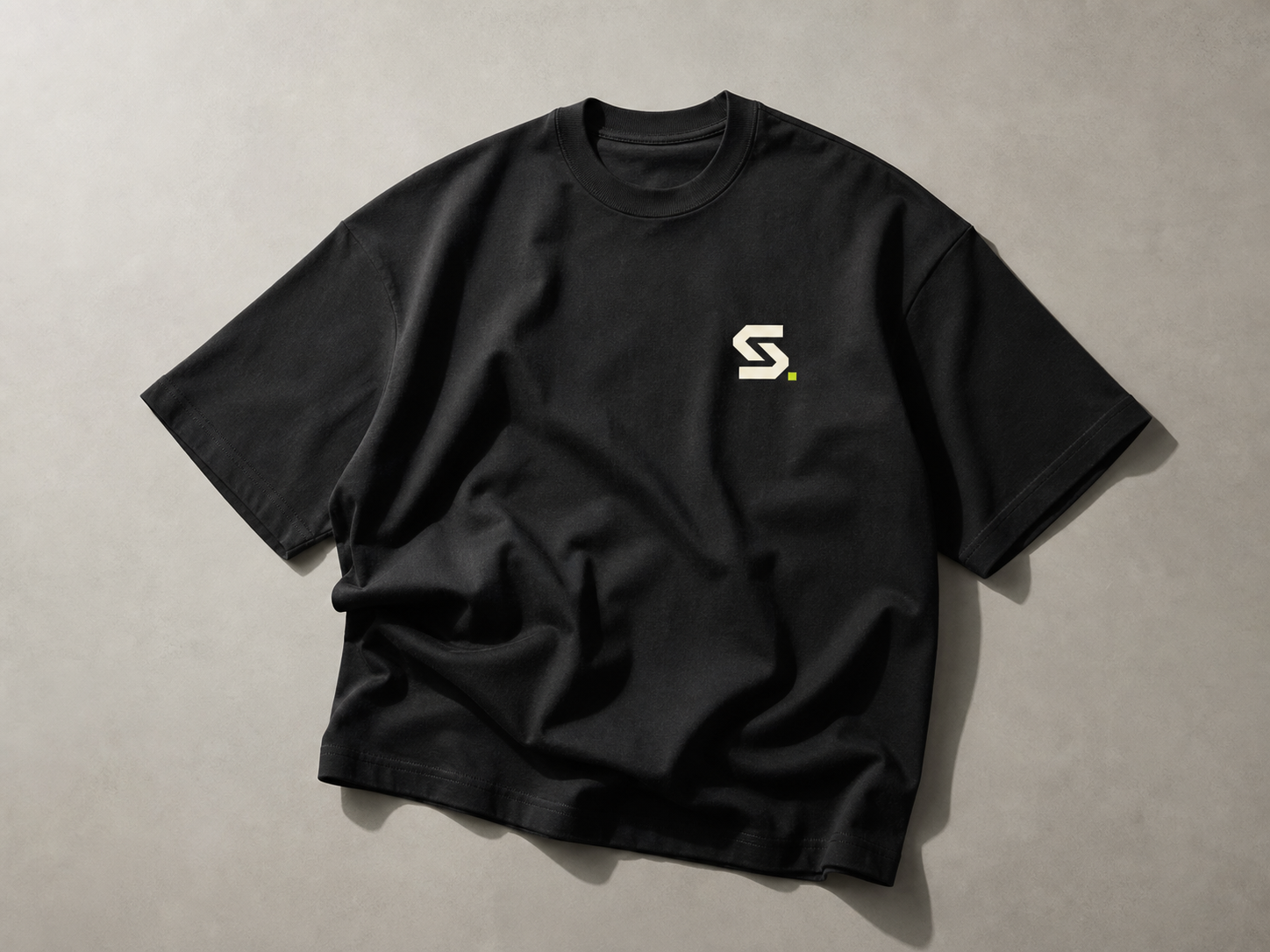 Minimal studio monogram applied to a heavyweight black T-shirt